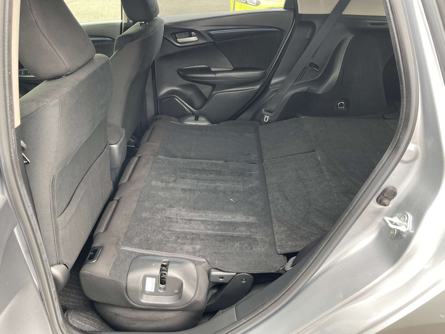 Interior view of 2019 Honda Shuttle 1.5L 4WD Hybrid with rear seats folded down for extra cargo space.
