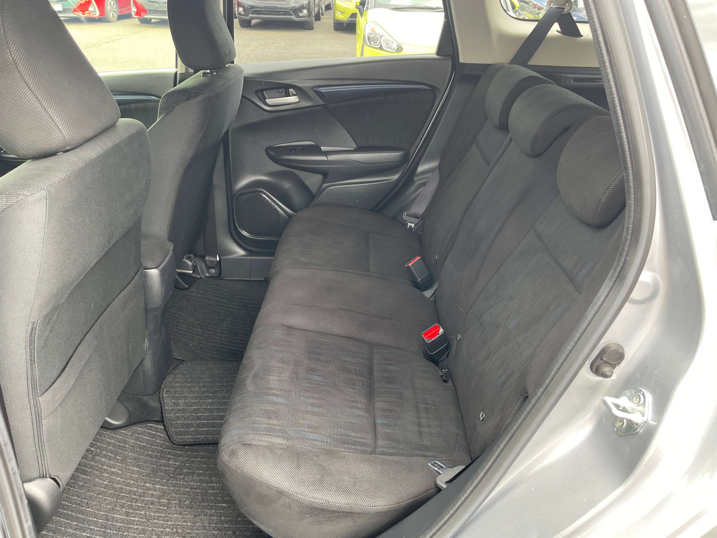 Interior view of the back seat of a 2019 Honda Shuttle 1.5L 4WD Hybrid, showcasing spacious and comfortable seating.