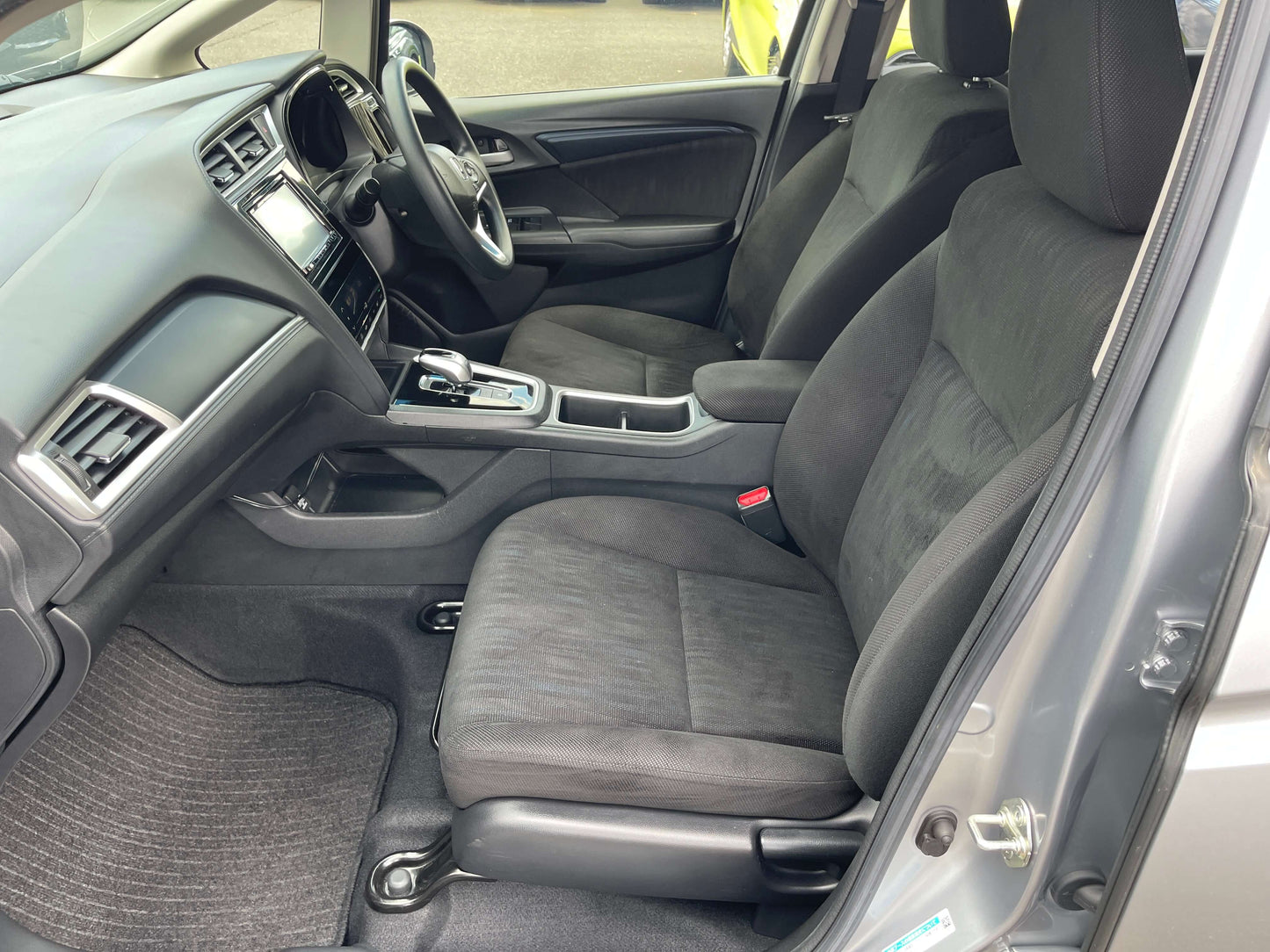 Interior view of a 2019 Honda Shuttle 1.5L 4WD Hybrid X Honda Sensing Edition showing spacious seating and dashboard.