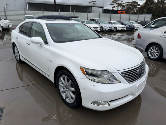 2007 Lexus LS600h AWD V8 5.0L Hybrid luxury sedan parked with other vehicles in background.