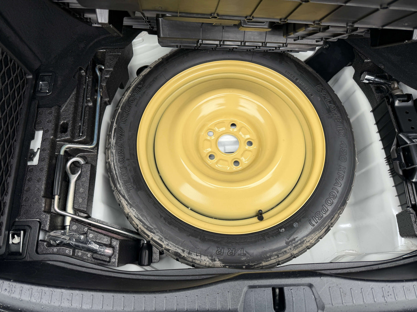 2007 Lexus LS600h AWD V8 5.0L Hybrid spare tire storage compartment with yellow wheel