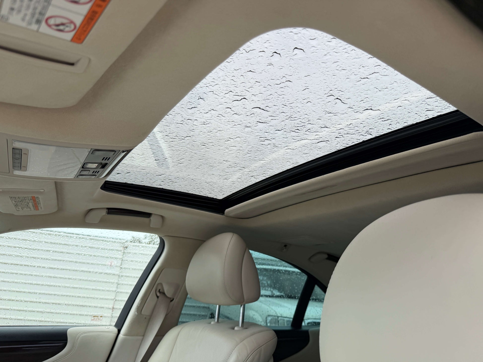 Interior sunroof view of 2007 Lexus LS600h AWD V8 5.0L Hybrid luxury sedan with rain.