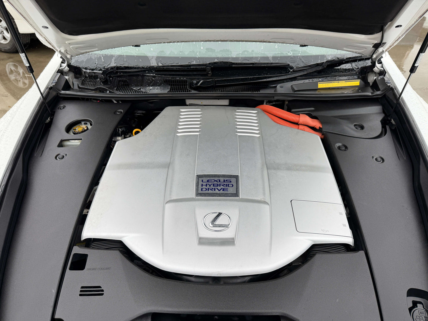 Engine compartment of 2007 Lexus LS600h AWD V8 5.0L Hybrid showing hybrid drive components.