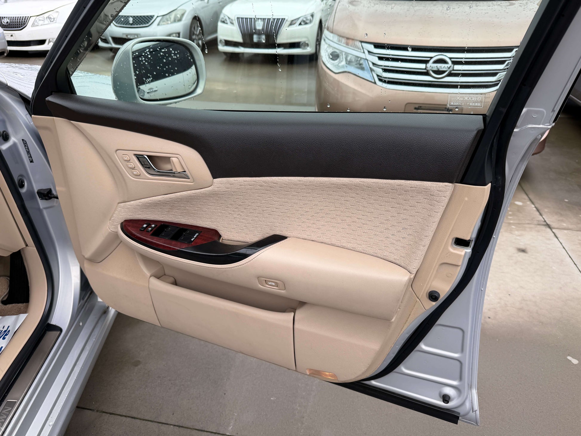 Interior view of the 2008 Toyota Crown V6 3.0L Royal Saloon luxury sedan showing the door panel and handle.