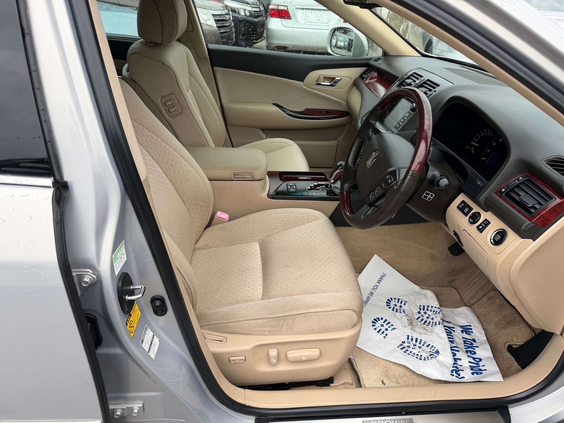 Interior view of a 2008 Toyota Crown V6 3.0L Royal Saloon Luxury Sedan showcasing beige seats and dashboard.