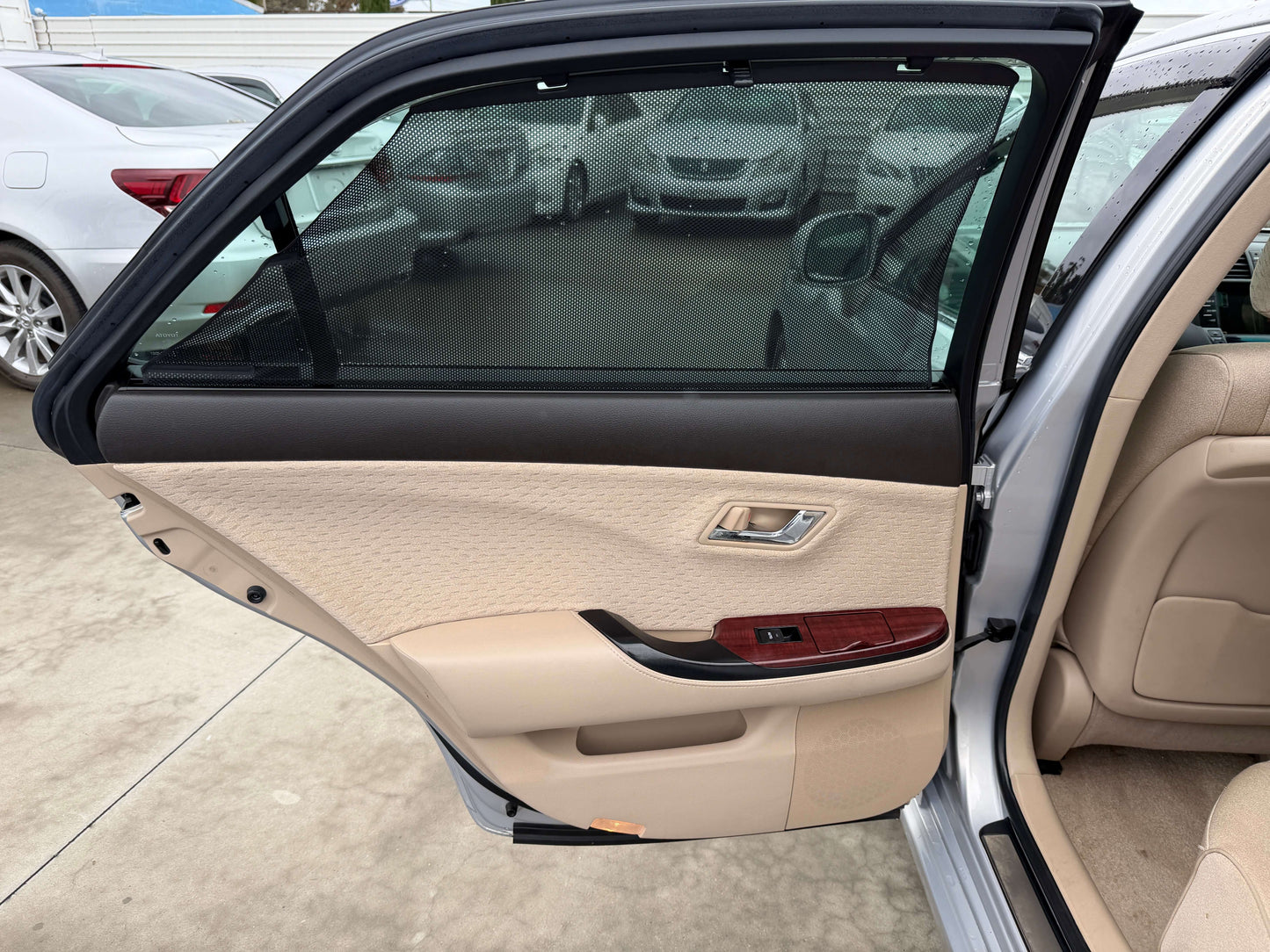 Interior view of the 2008 Toyota Crown V6 3.0L Royal Saloon Luxury Sedan door, showcasing beige upholstery and window.