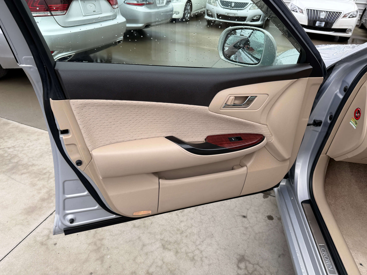 Interior view of the 2008 Toyota Crown V6 3.0L Royal Saloon G-Edition luxury sedan door panel with beige upholstery.