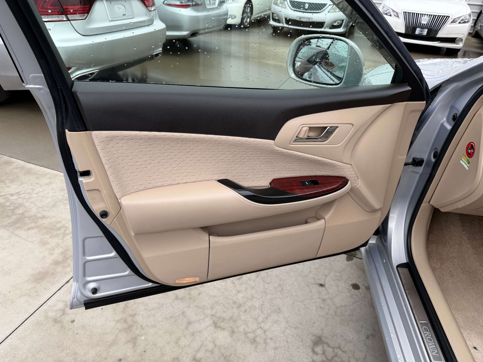 Interior view of the 2008 Toyota Crown V6 3.0L Royal Saloon G-Edition luxury sedan door panel with beige upholstery.
