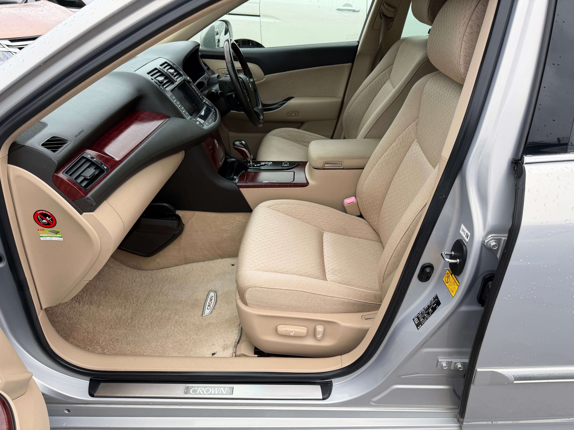Interior view of 2008 Toyota Crown V6 3.0L Royal Saloon Luxury Sedan showing beige seats and dashboard.