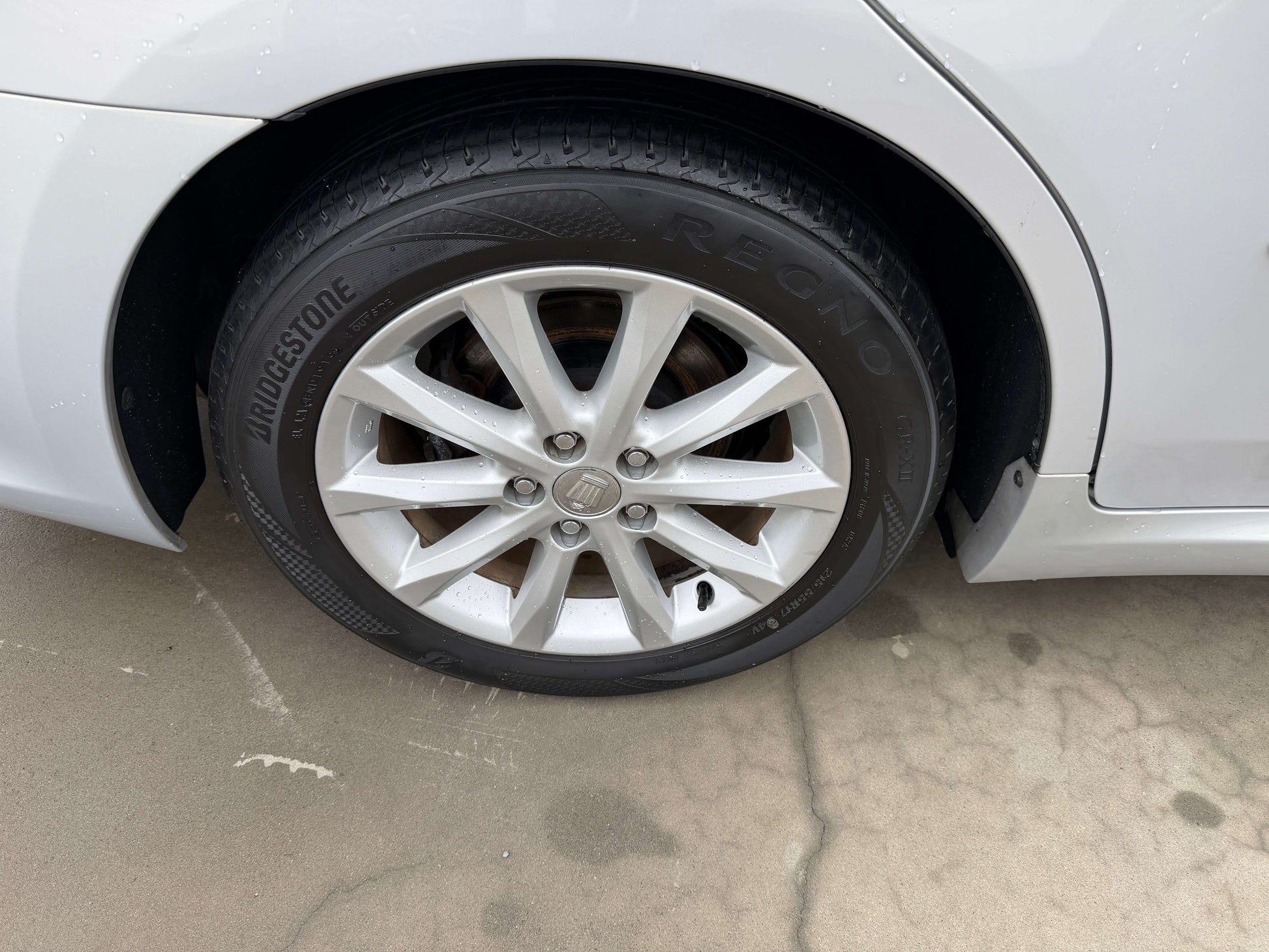 Close-up of a 2008 Toyota Crown V6 3.0L wheel with Bridgestone tire, showcasing luxury sedan design.
