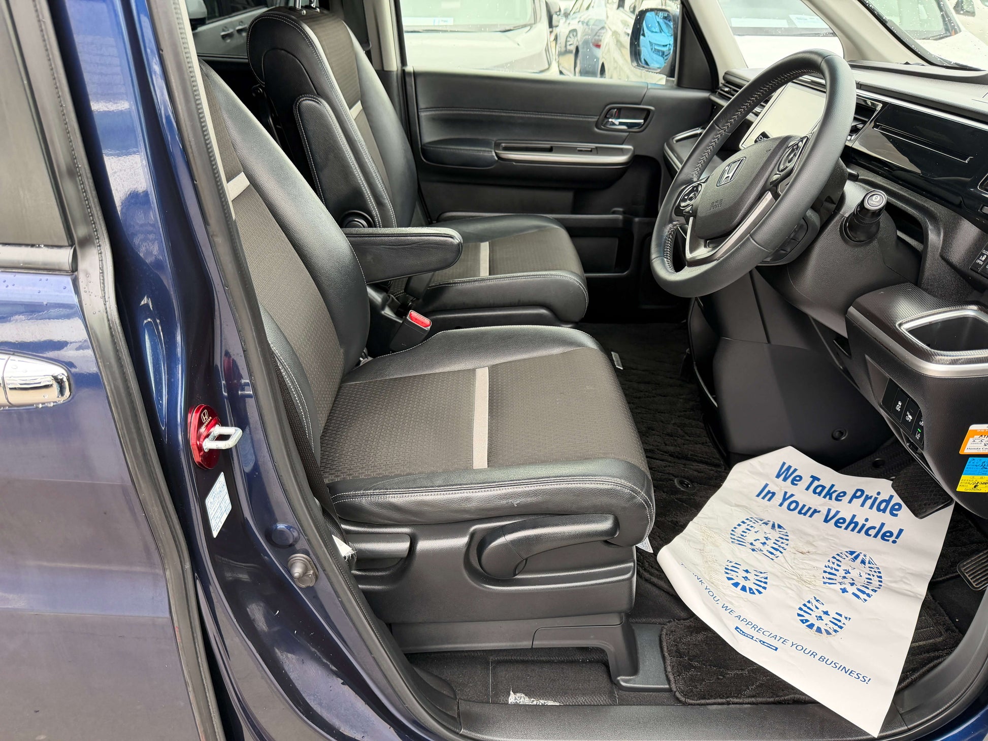 Interior view of the 2018 Honda Honda Stepwgn 2.0 Spada Hybrid with spacious seating and modern dashboard features.