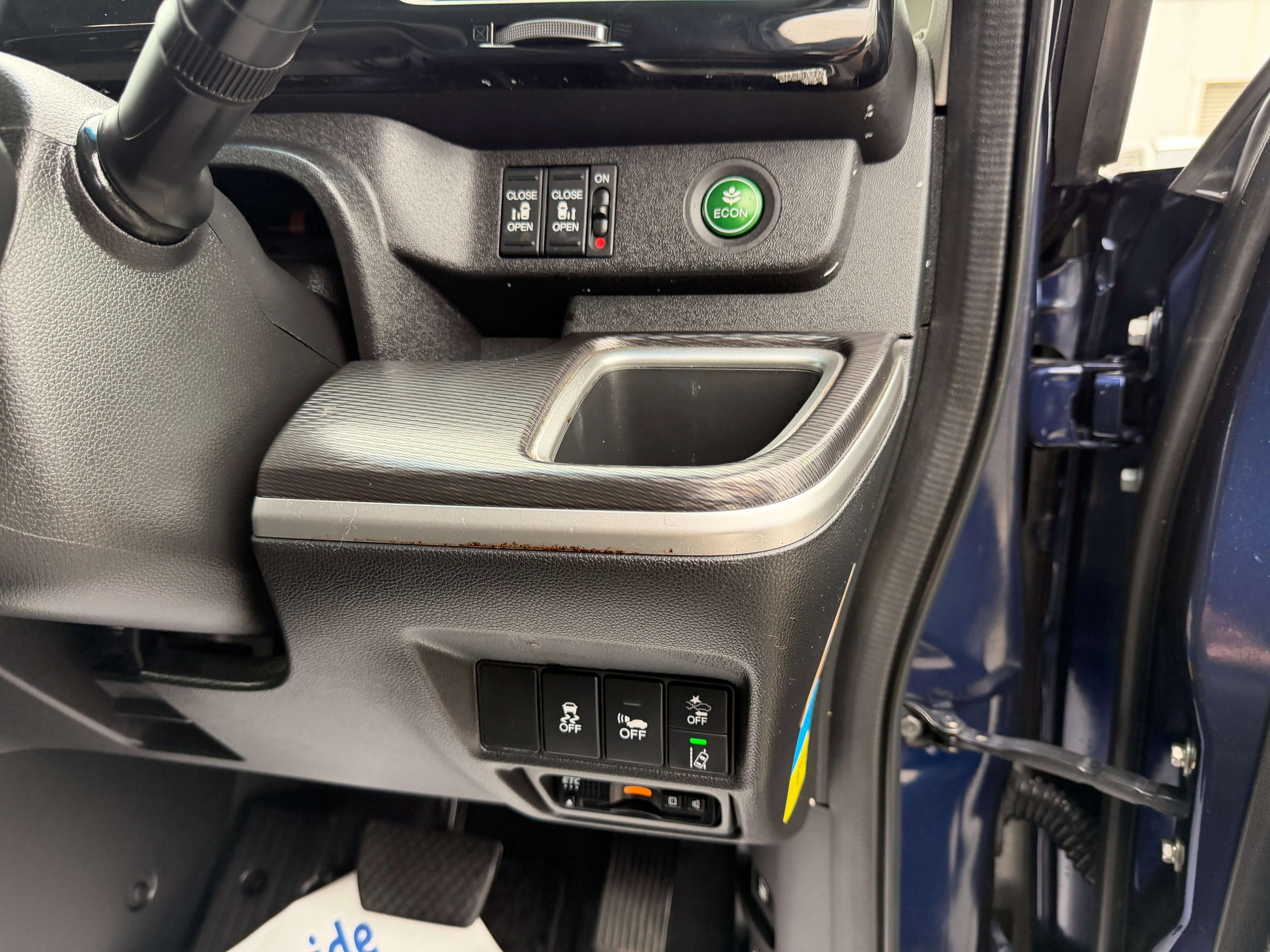 Interior console and controls of 2018 Honda Honda Stepwgn 2.0 Spada Hybrid, showcasing storage and button features.