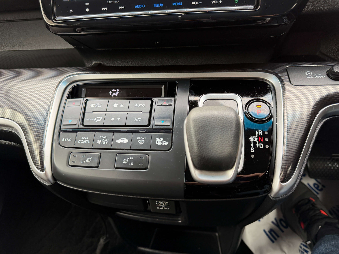 Interior control panel of 2018 Honda Honda Stepwgn 2.0 Spada Hybrid with climate and gearshift options.