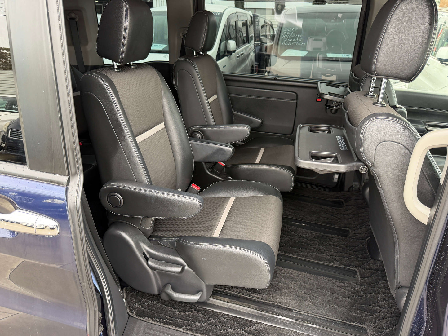 Interior view of the 2018 Honda Honda Stepwgn 2.0 Spada Hybrid G with spacious seating for 7, highlighting comfortable front seats.