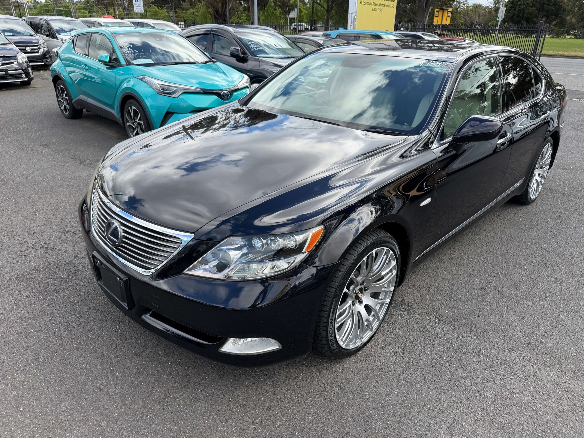 2007 Lexus LS600h AWD V8 5.0L Hybrid I Package Luxury Sedan in black with chrome accents, showcasing elegant design.