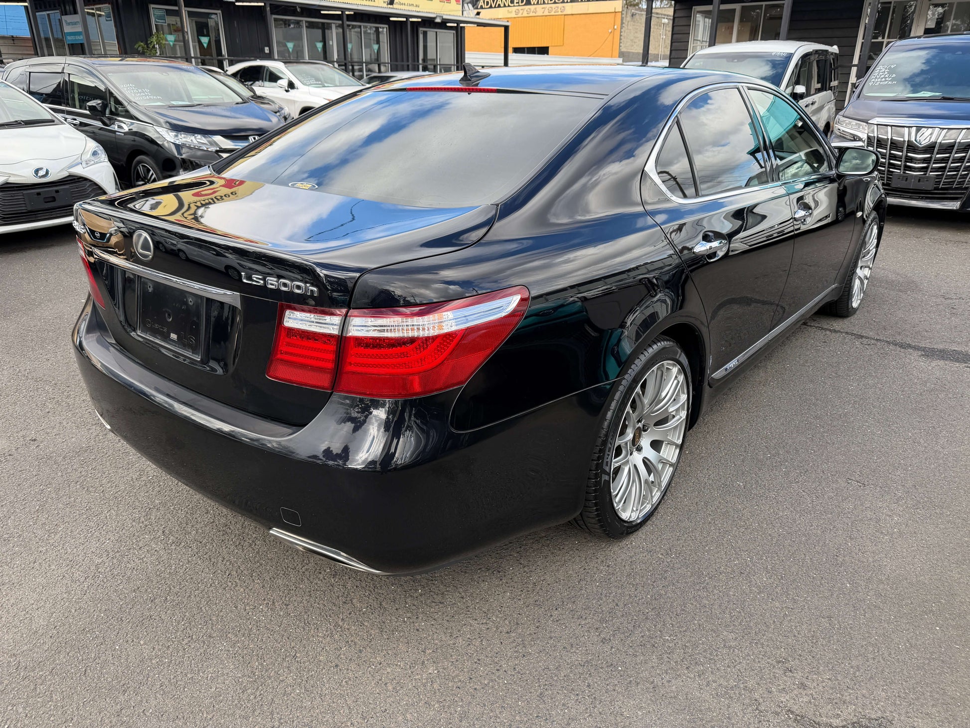 2007 Lexus LS600h AWD V8 5.0L Hybrid black luxury sedan rear view with shiny wheels