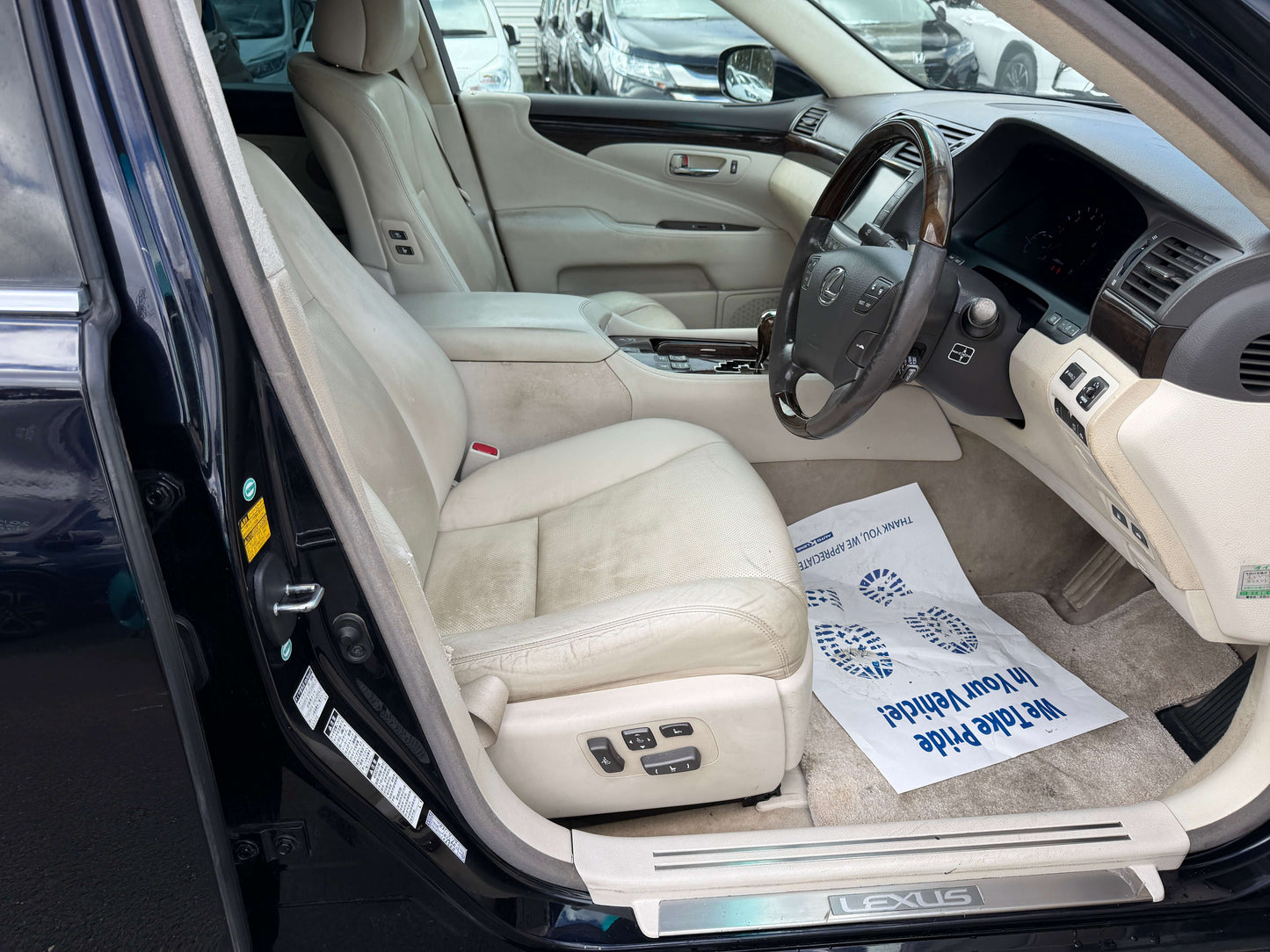 Interior view of a 2007 Lexus LS600h AWD V8 5.0L Hybrid luxury sedan showing the dashboard and leather seats.