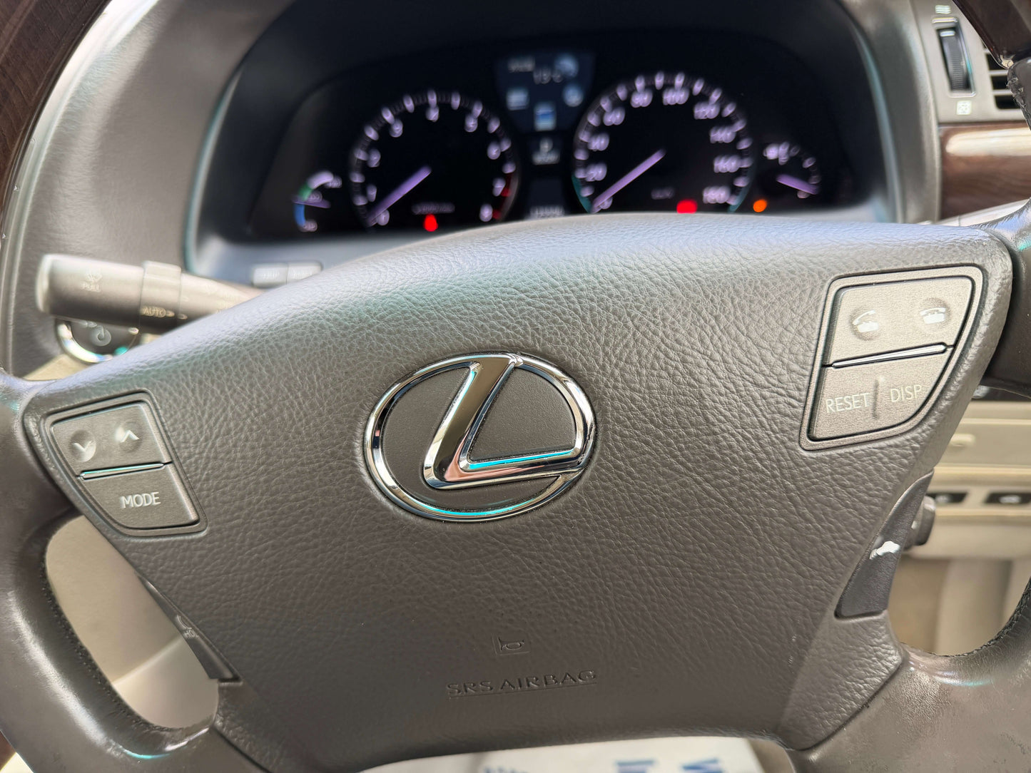 2007 Lexus LS600h AWD V8 5.0L Hybrid steering wheel with controls and dashboard display.