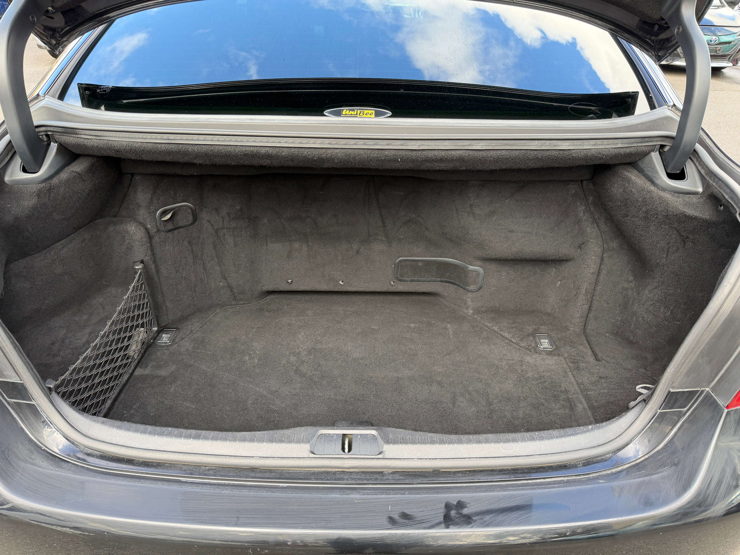 Cargo trunk space of 2007 Lexus LS600h AWD V8 5.0L Hybrid Sedan, empty with carpeted interior.