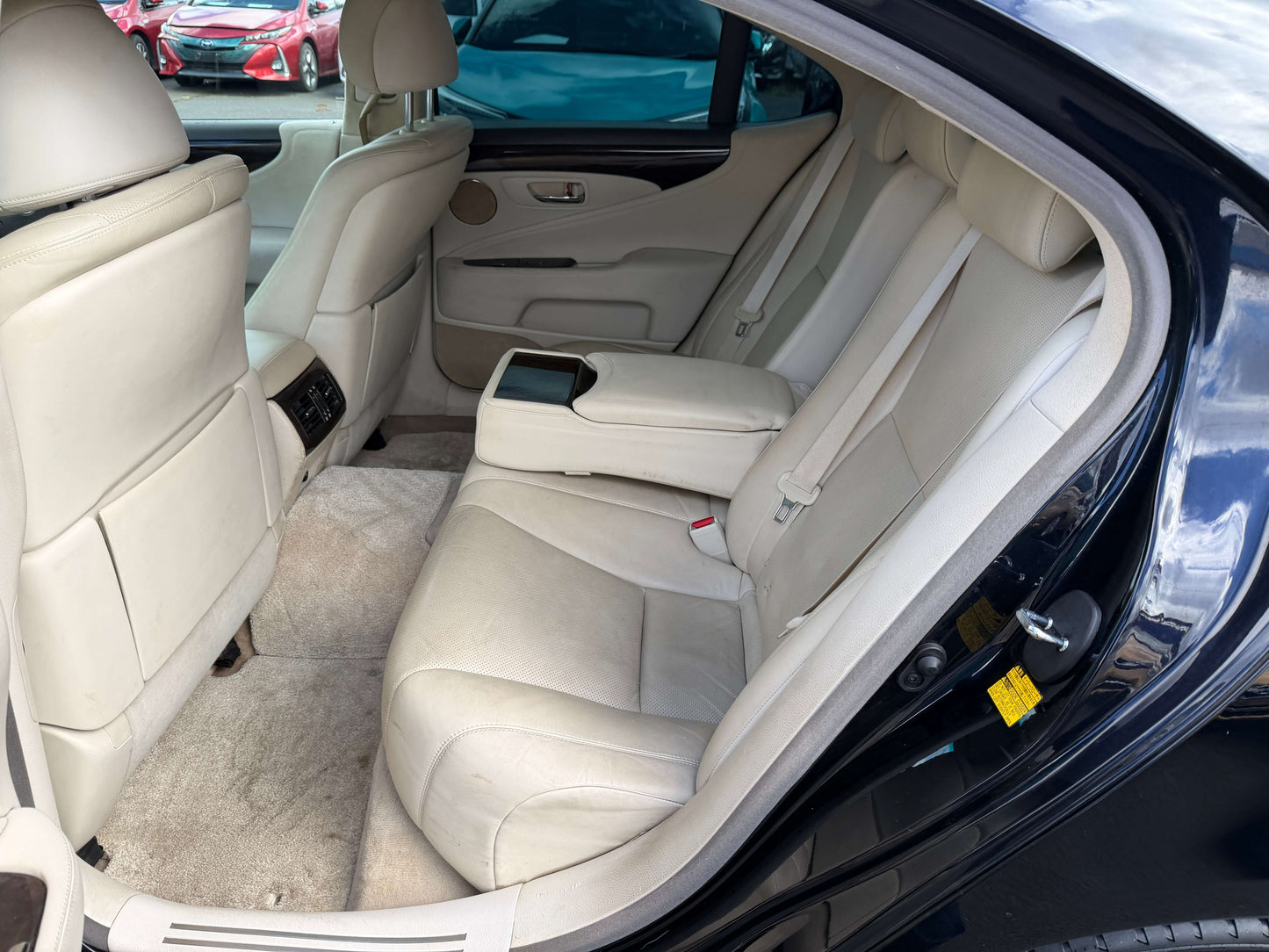 Interior view showing back seat of 2007 Lexus LS600h AWD V8 5.0L Hybrid Luxury Sedan with cream leather upholstery.