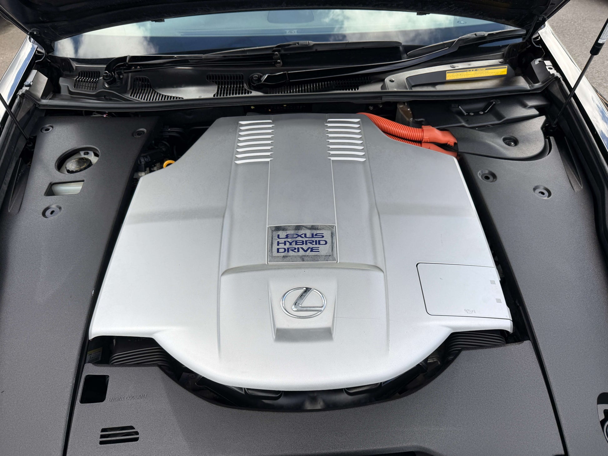 Engine compartment of a 2007 Lexus LS600h AWD V8 5.0L Hybrid showcasing the Lexus Hybrid Drive technology.
