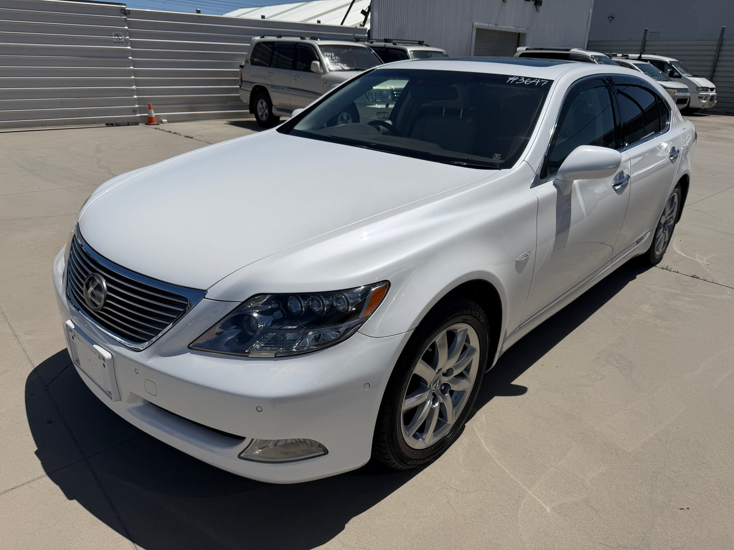 2007 Lexus LS600hL AWD V8 5.0L Hybrid Luxury Sedan in white, exterior view, showcasing sleek design and luxury features.