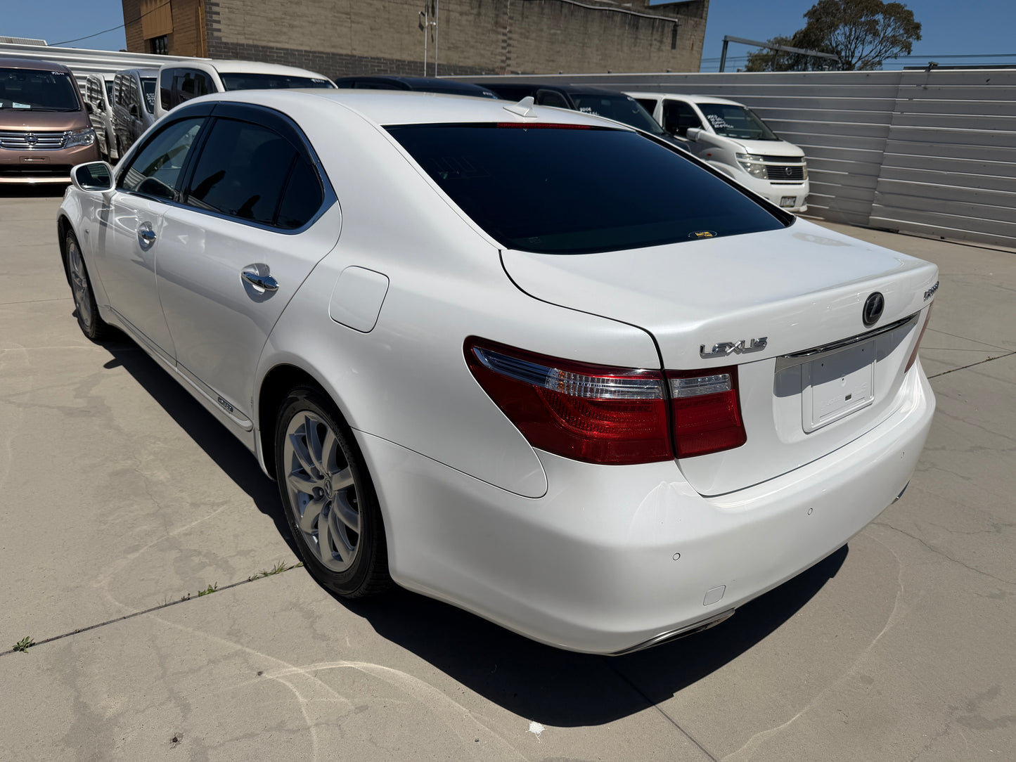 2007 Lexus LS600hL AWD V8 5.0L Hybrid Luxury Sedan rear view in white color, showcasing its elegant design and features.