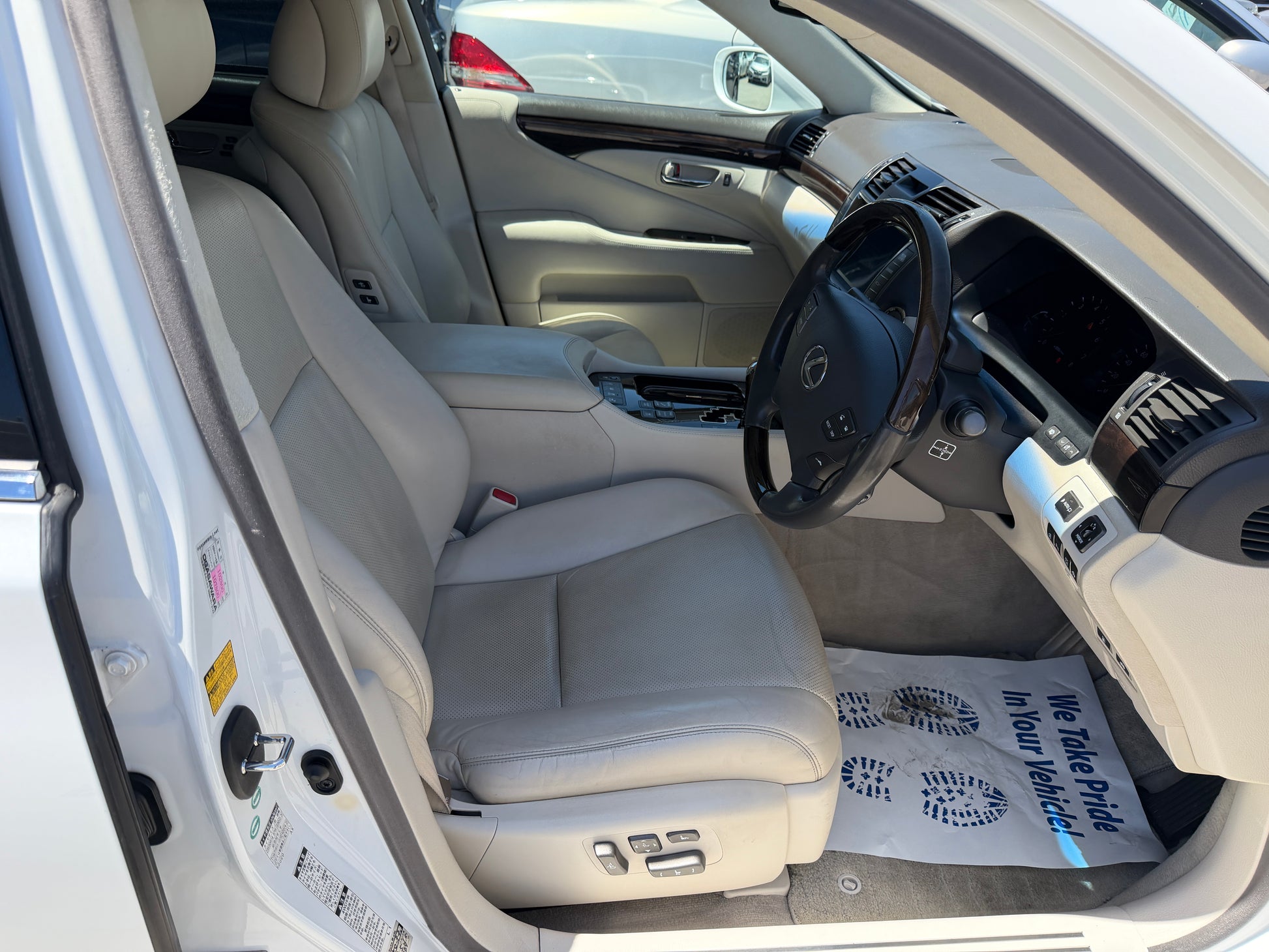 Interior view of a 2007 Lexus LS600hL AWD V8 5.0L Hybrid Luxury Sedan featuring leather seats.