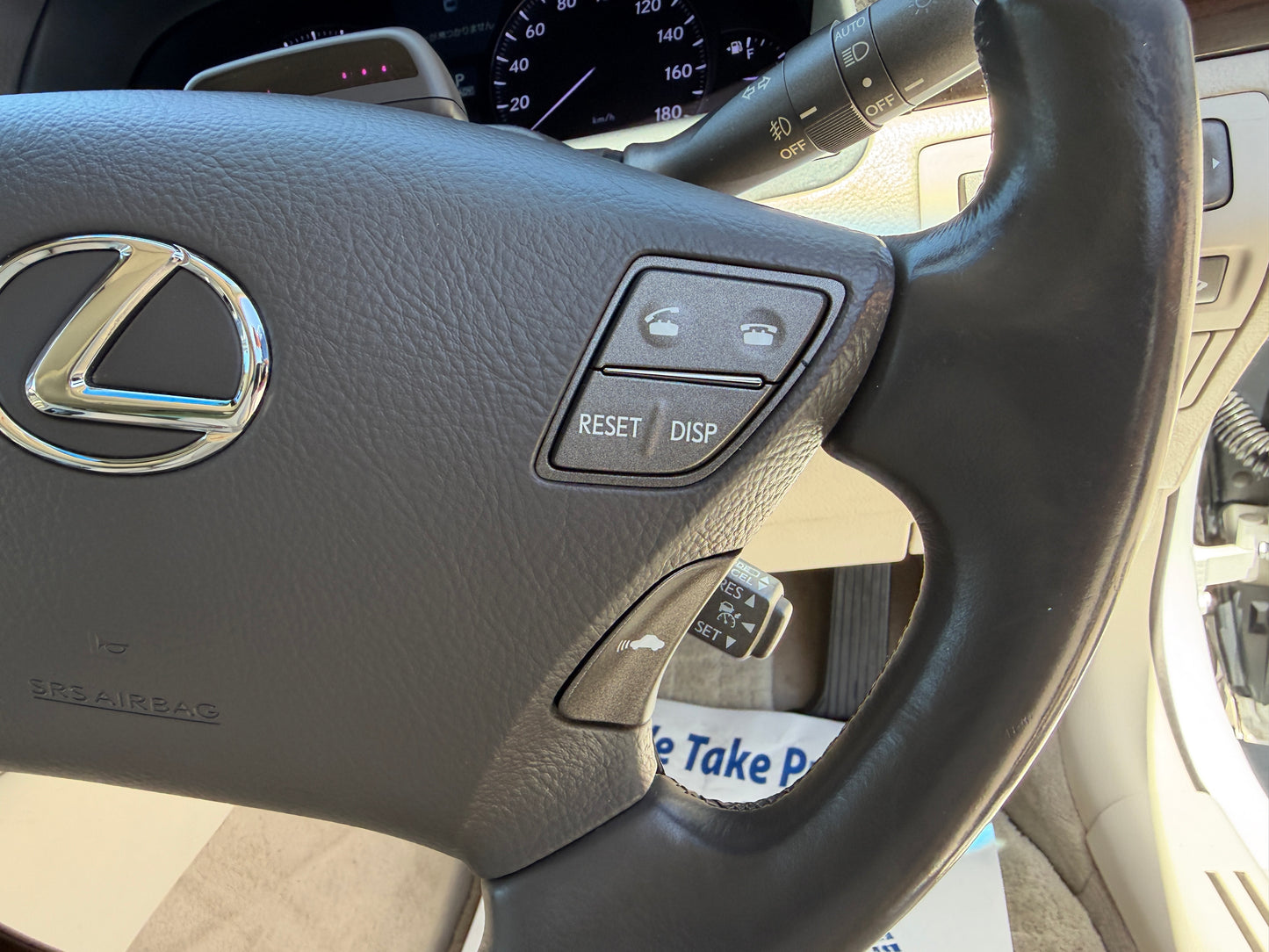 Close-up of the Lexus steering wheel with controls for reset and display in a 2007 Lexus LS600hL AWD V8 5.0L Hybrid luxury sedan.