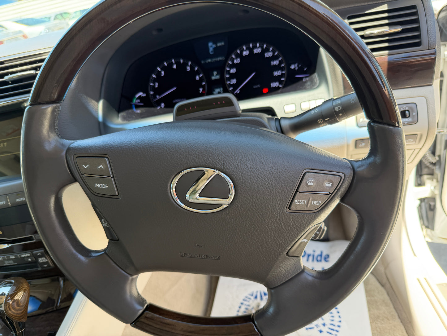 2007 Lexus LS600hL AWD V8 5.0L Hybrid luxury sedan steering wheel with control buttons.
