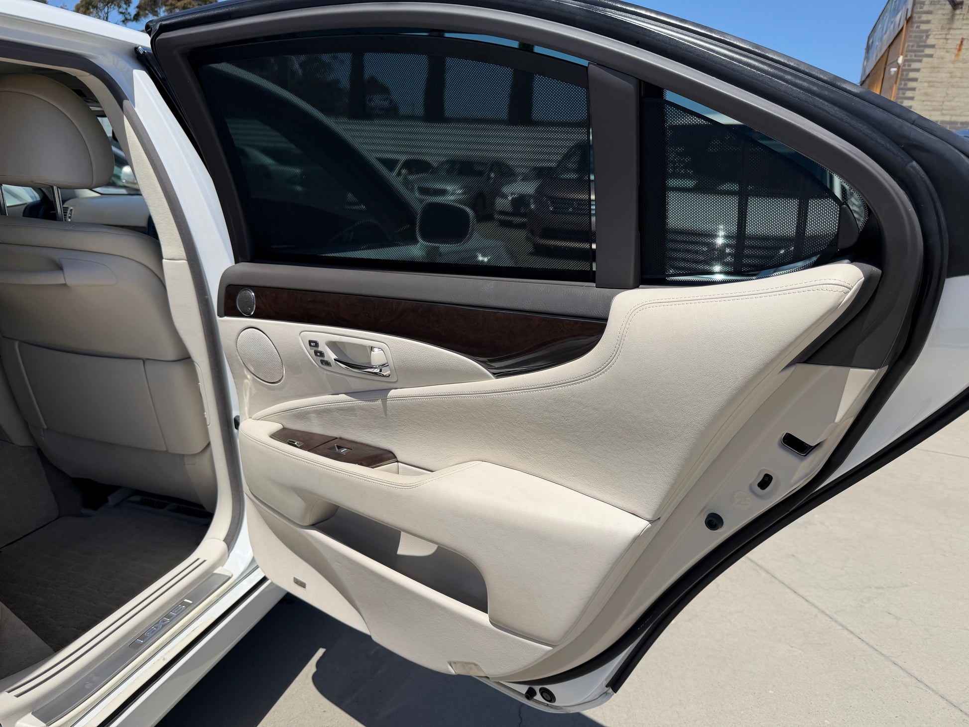 Interior view of the 2007 Lexus LS600hL AWD V8 5.0L Hybrid Luxury Sedan door detailing and upholstery.