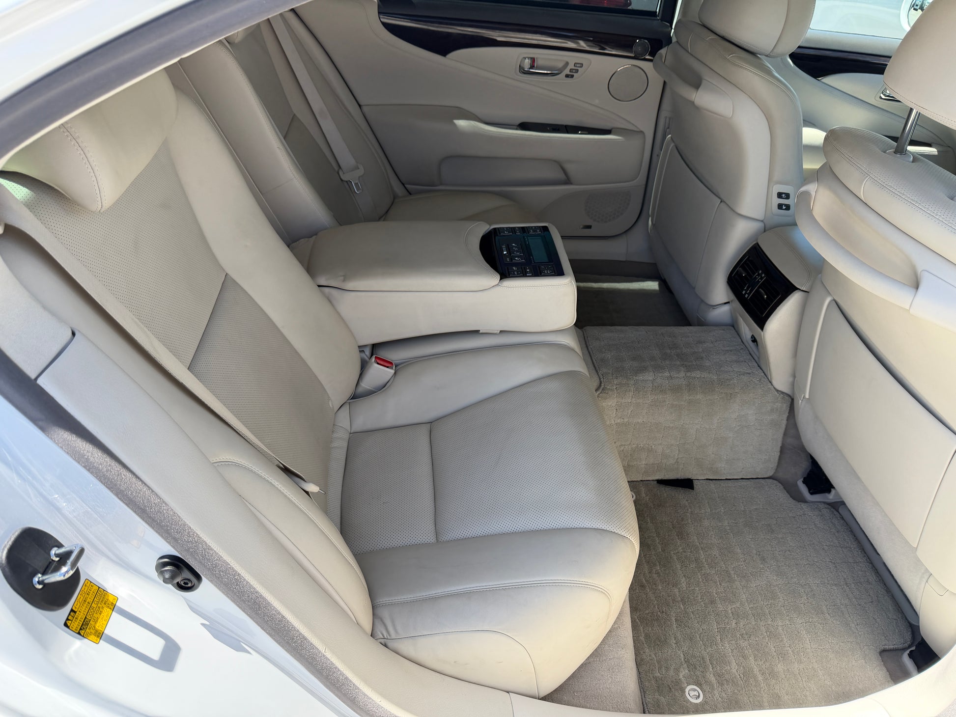 2007 Lexus LS600hL AWD V8 5.0L Hybrid Luxury Sedan back seat interior with beige leather upholstery.