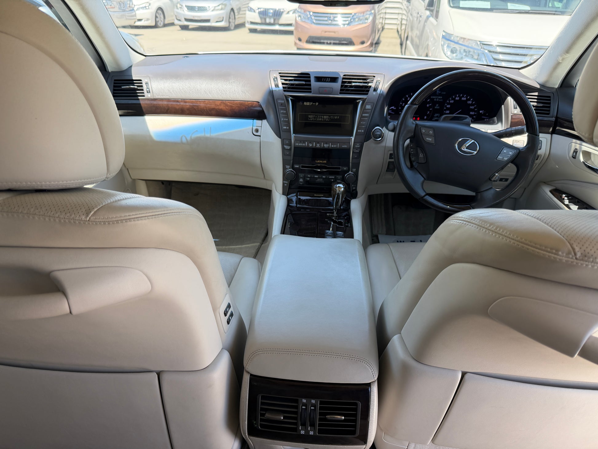 Interior view of a 2007 Lexus LS600hL AWD V8 5.0L Hybrid Luxury Sedan, showcasing leather seats and dashboard features.