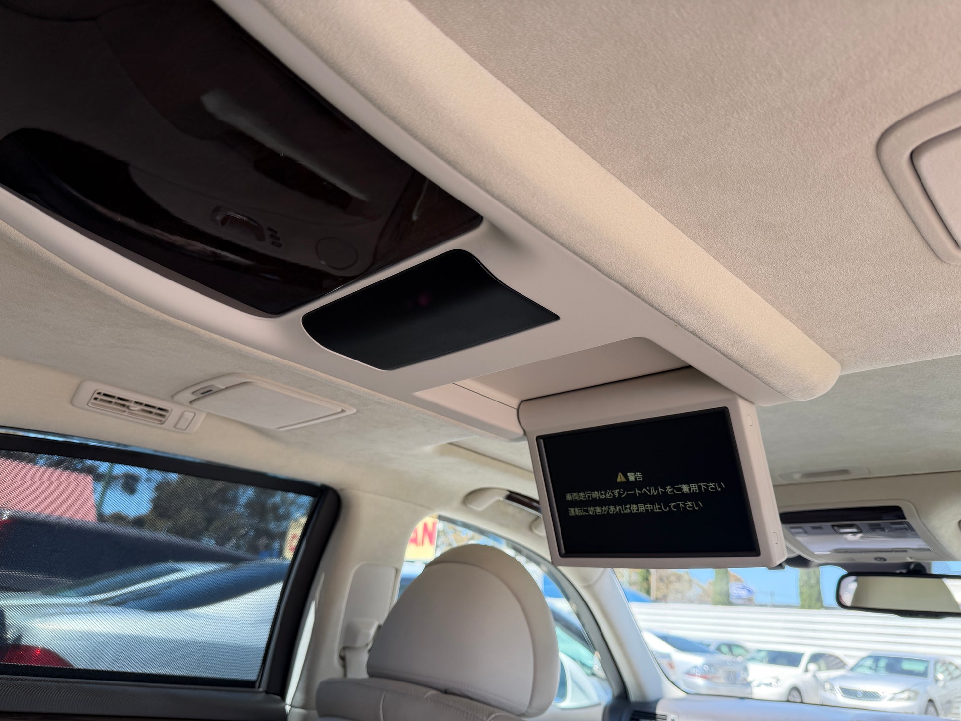 Interior view of the 2007 Lexus LS600hL AWD V8 5.0L Hybrid sedan showing overhead monitor and control panel.