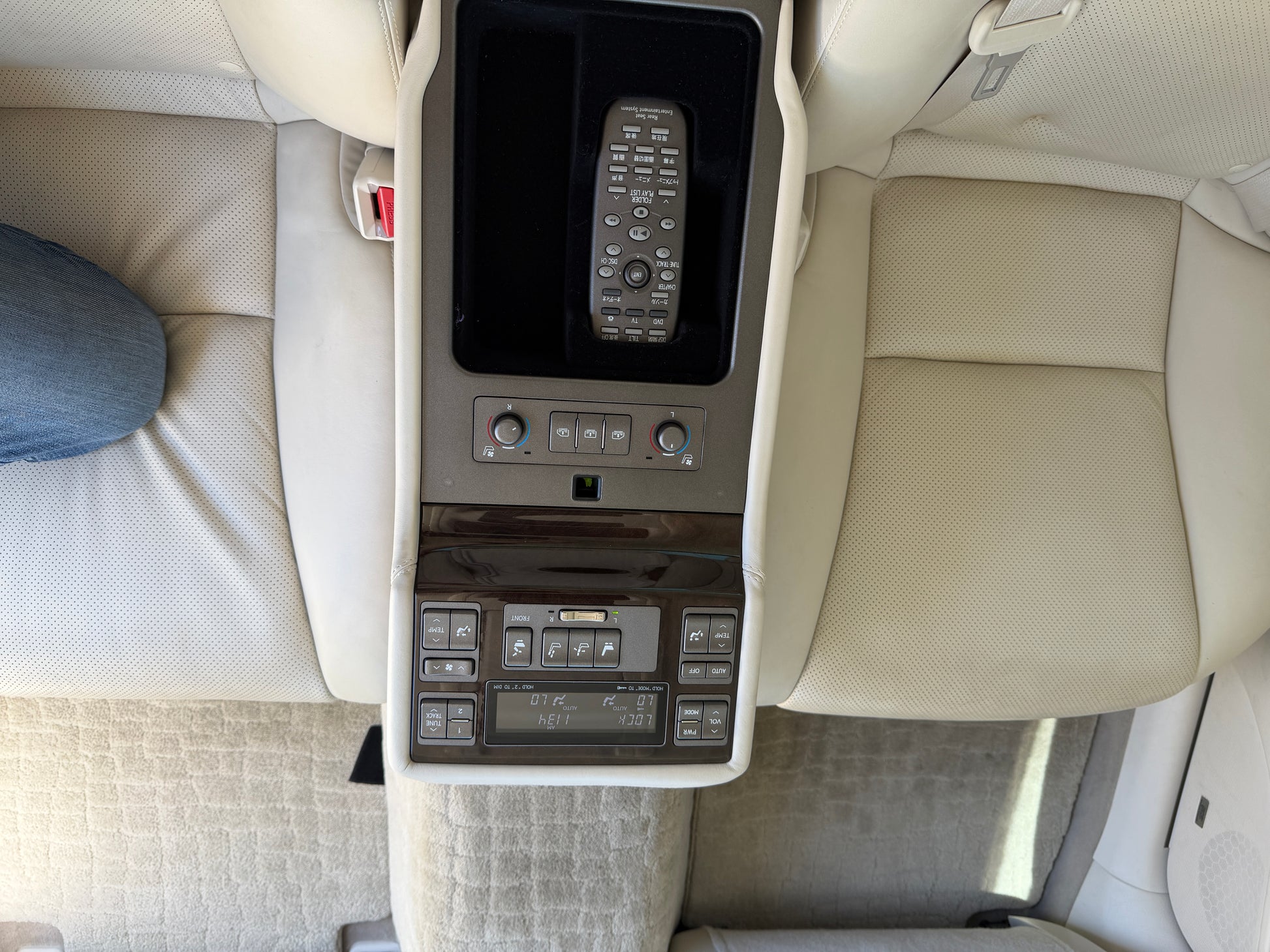 Interior view of 2007 Lexus LS600hL AWD V8 5.0L Hybrid Luxury Sedan center console with controls and remote.