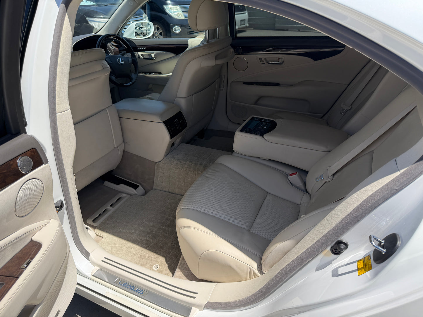 Interior view of a 2007 Lexus LS600hL AWD V8 5.0L Hybrid Luxury Sedan showcasing leather seats and elegant design.