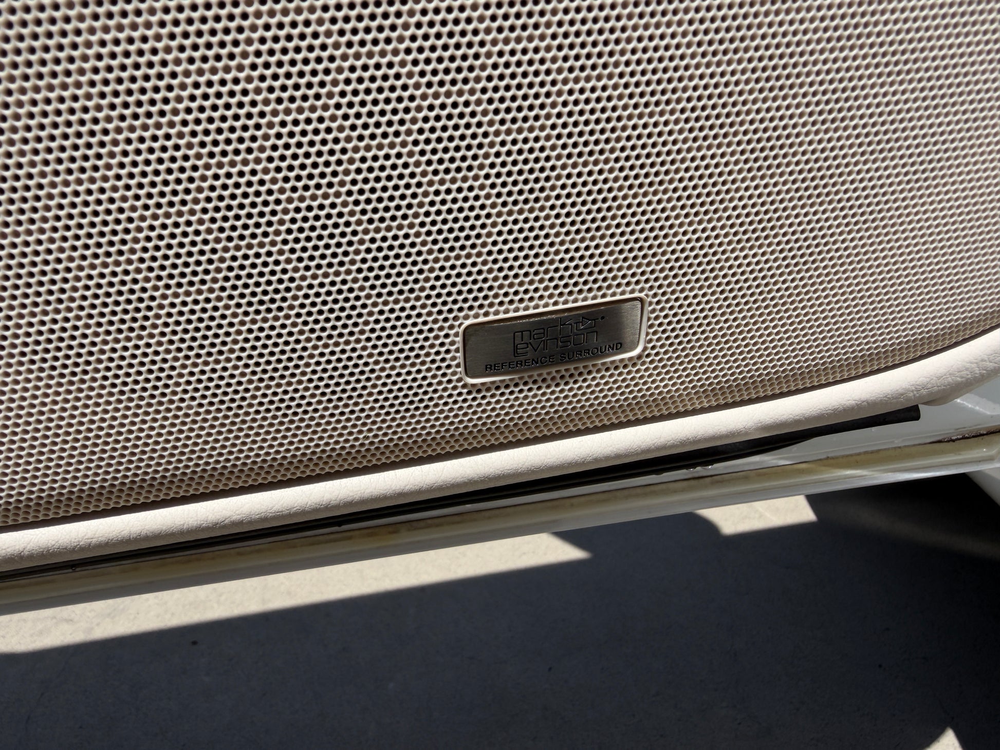 2007 Lexus LS600hL AWD V8 5.0L Hybrid Close-up of the premium sound system speaker grille in a luxury vehicle, featuring a brand logo.