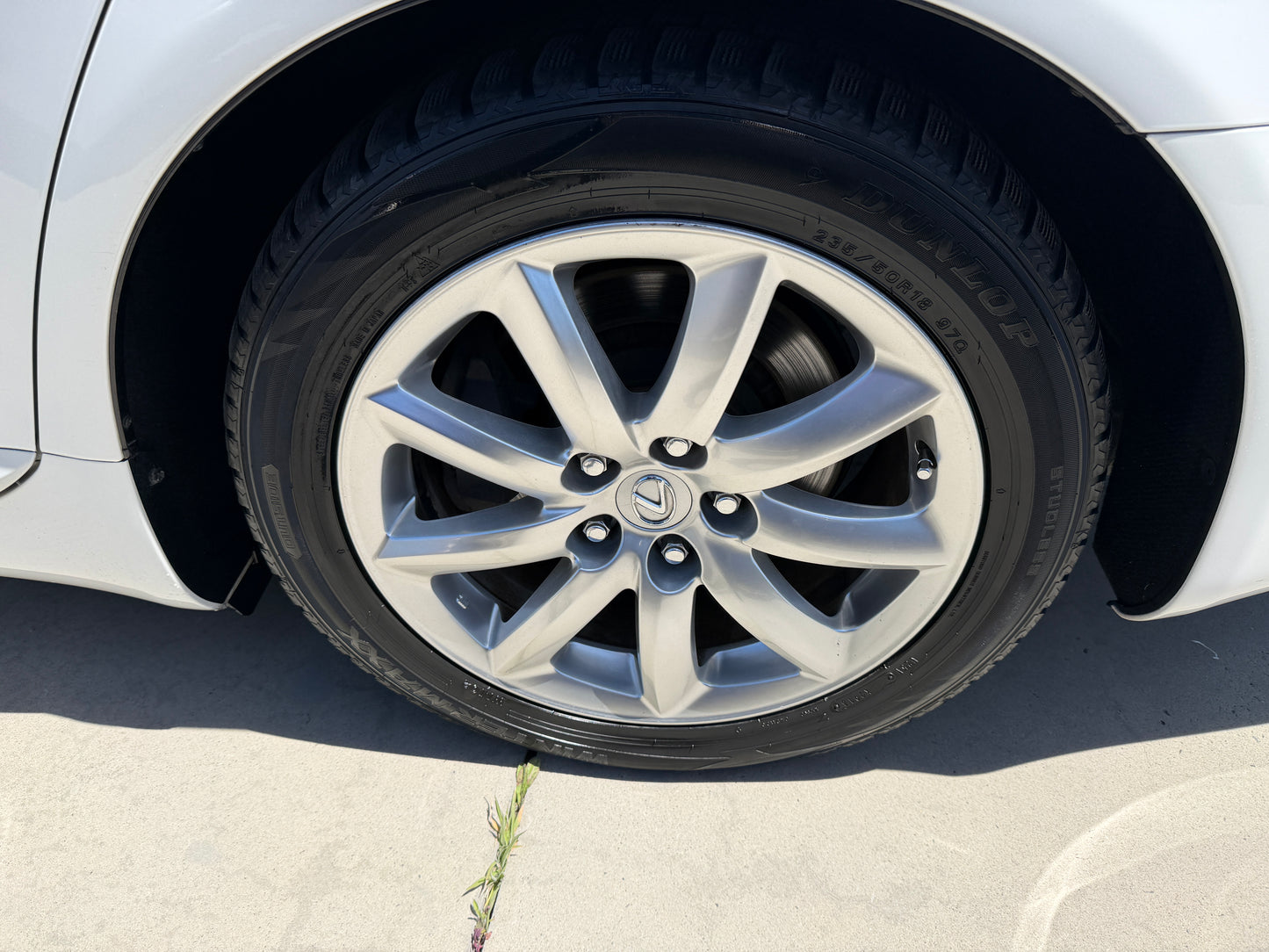 Close-up of a silver alloy wheel on a 2007 Lexus LS600hL AWD V8 5.0L Hybrid Luxury Sedan with tire tread visible.