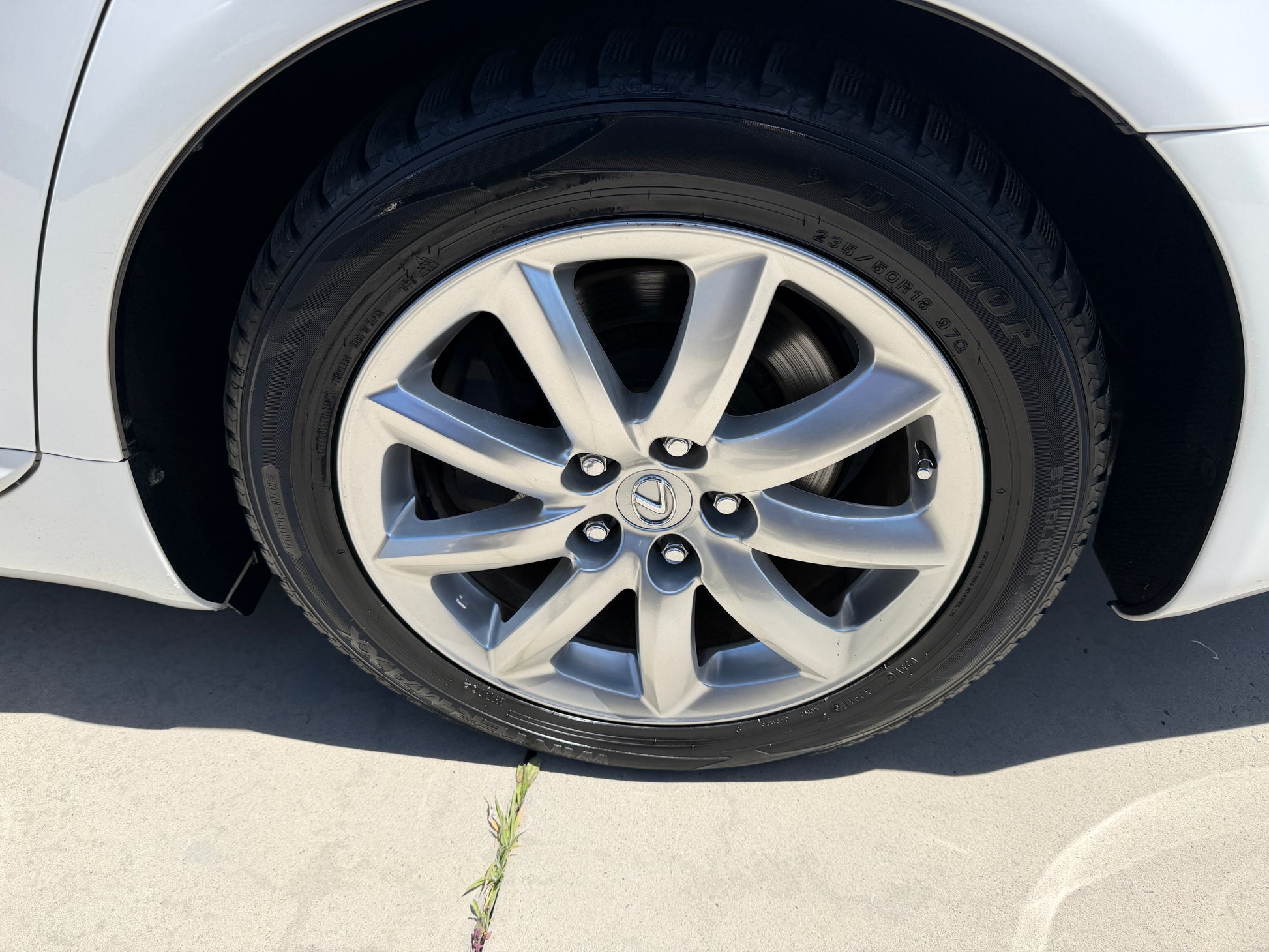 Close-up of a silver alloy wheel on a 2007 Lexus LS600hL AWD V8 5.0L Hybrid Luxury Sedan with tire tread visible.