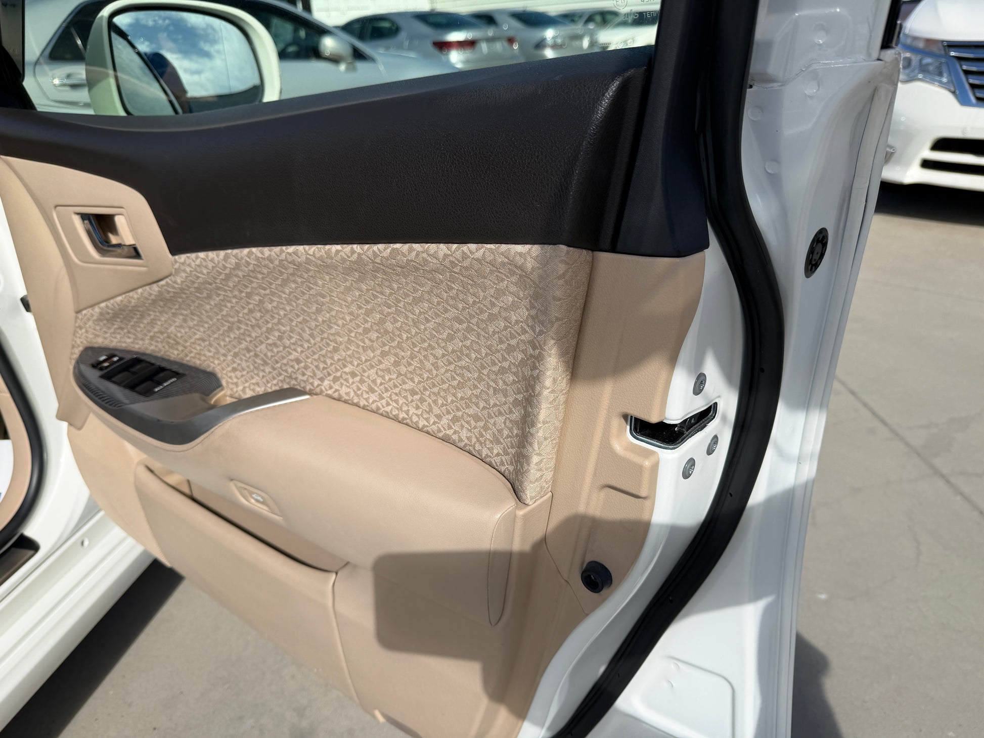 Interior view of the door panel of a 2012 Toyota Crown V6 3.5L Hybrid Luxury Sedan, showcasing luxurious materials.