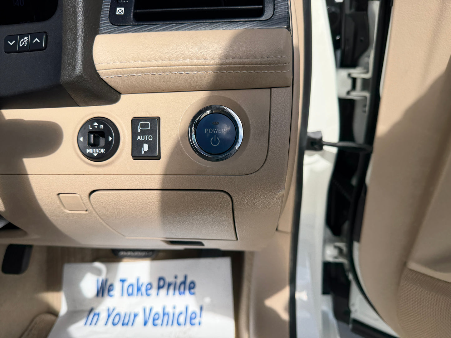Interior view showing power button and controls of a 2012 Toyota Crown V6 3.5L Hybrid Luxury Sedan.
