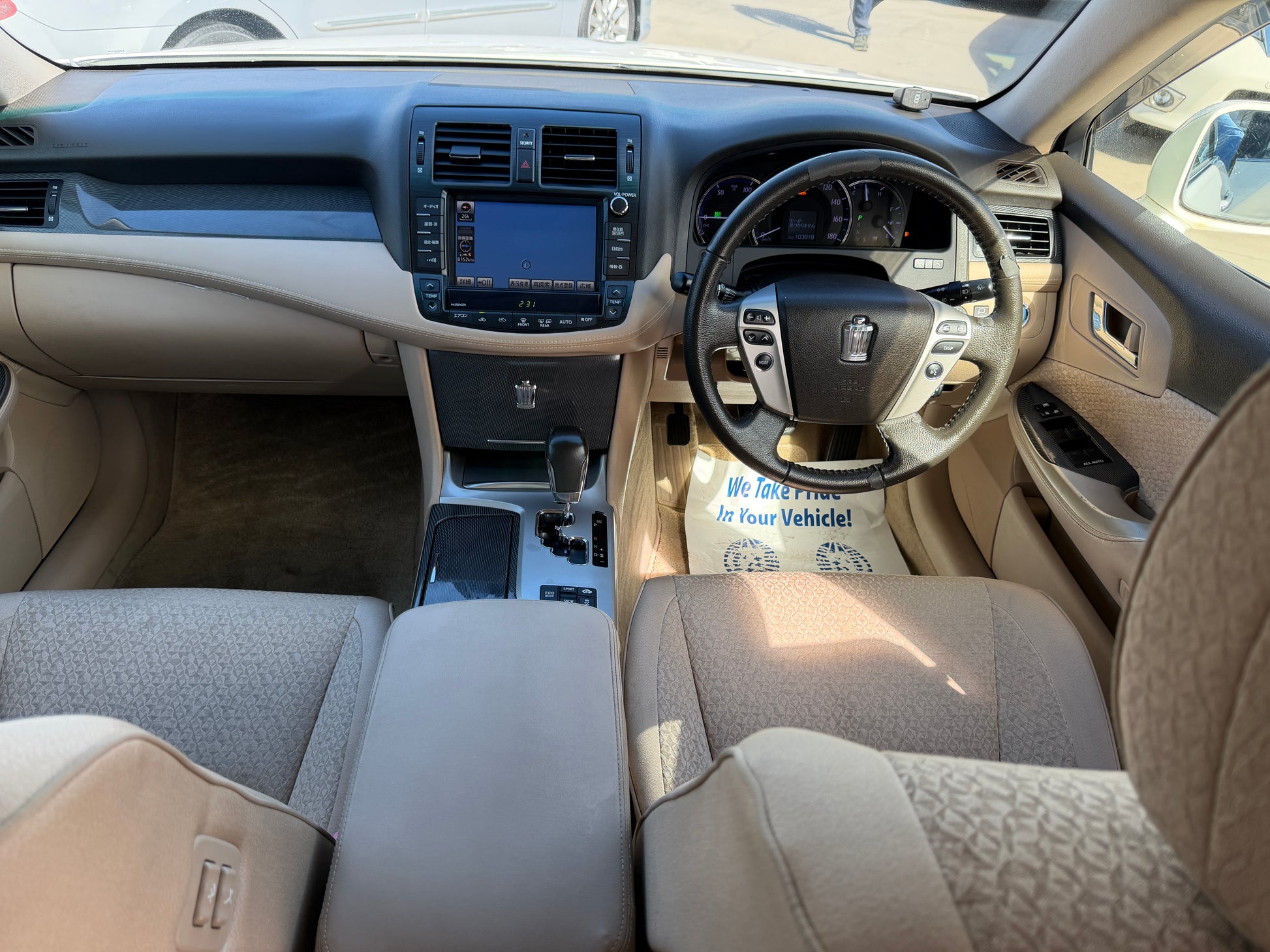 Interior view of the 2012 Toyota Crown V6 3.5L Hybrid Luxury Sedan, showcasing dashboard and seating.