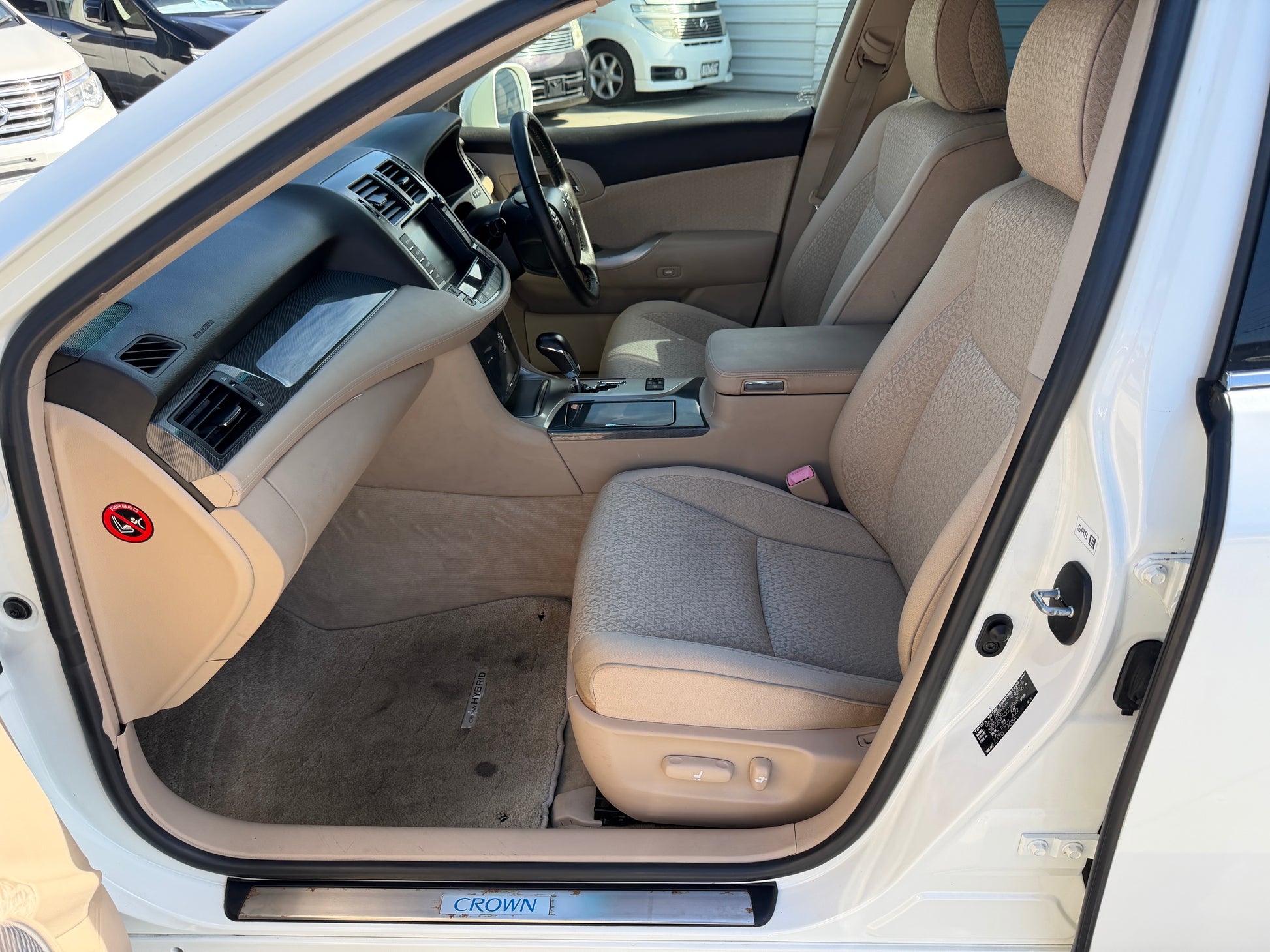 Interior view of 2012 Toyota Crown V6 3.5L Hybrid Luxury Sedan showcasing seats and dashboard.