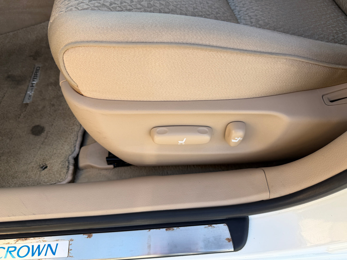 Side view of the adjustable seat controls in a 2012 Toyota Crown V6 3.5L Hybrid Luxury Sedan interior.