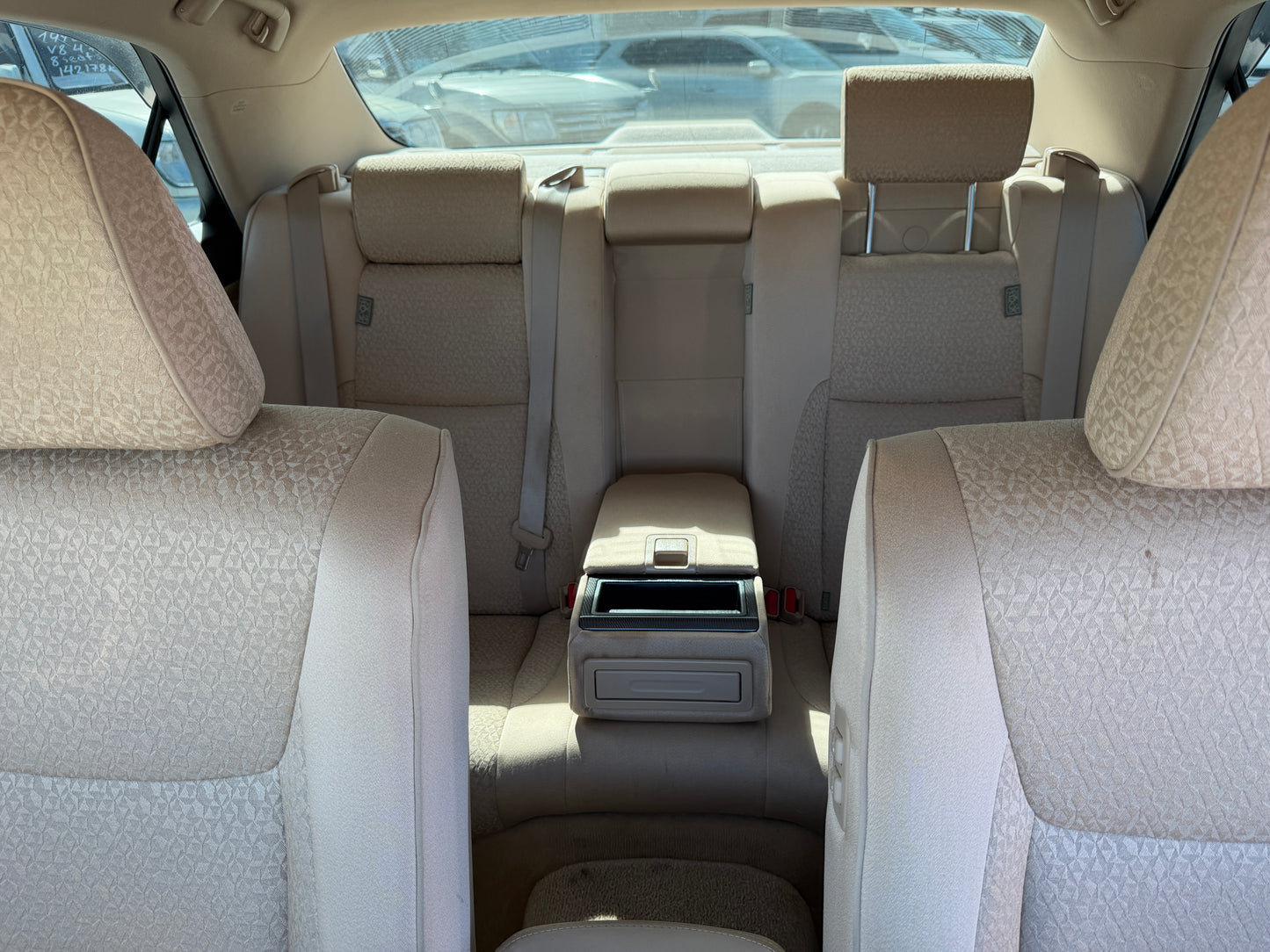 Interior view of the back seats of a 2012 Toyota Crown V6 3.5L Hybrid Luxury Sedan, showcasing spacious and elegant seating.