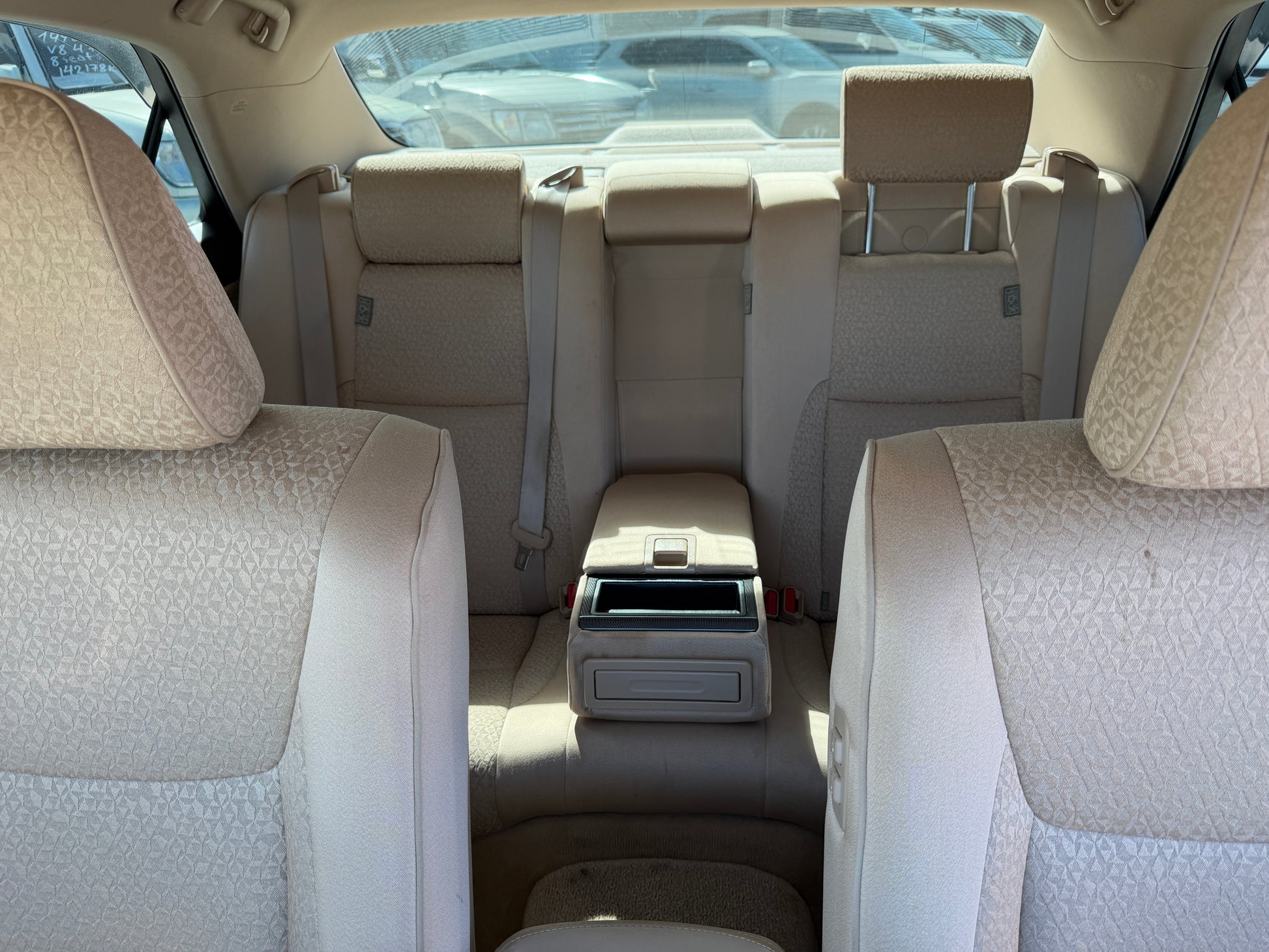 Interior view of the back seats of a 2012 Toyota Crown V6 3.5L Hybrid Luxury Sedan, showcasing spacious and elegant seating.