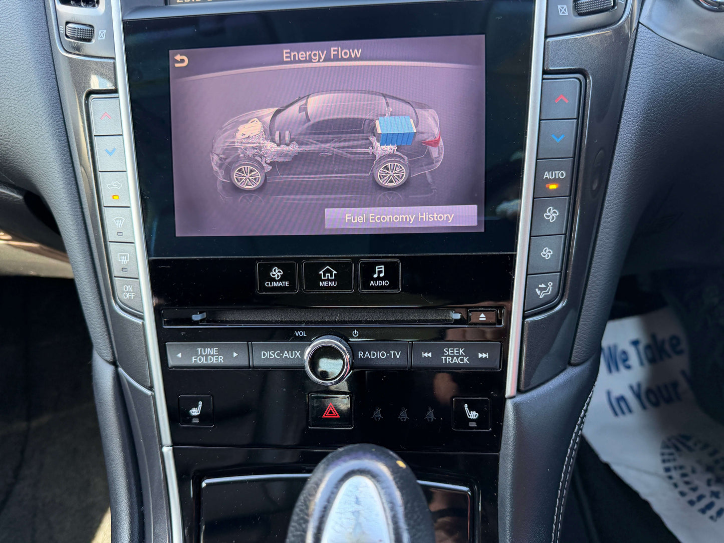 2014 Nissan Skyline V6 3.5L Hybrid screen displaying energy flow and fuel economy history.