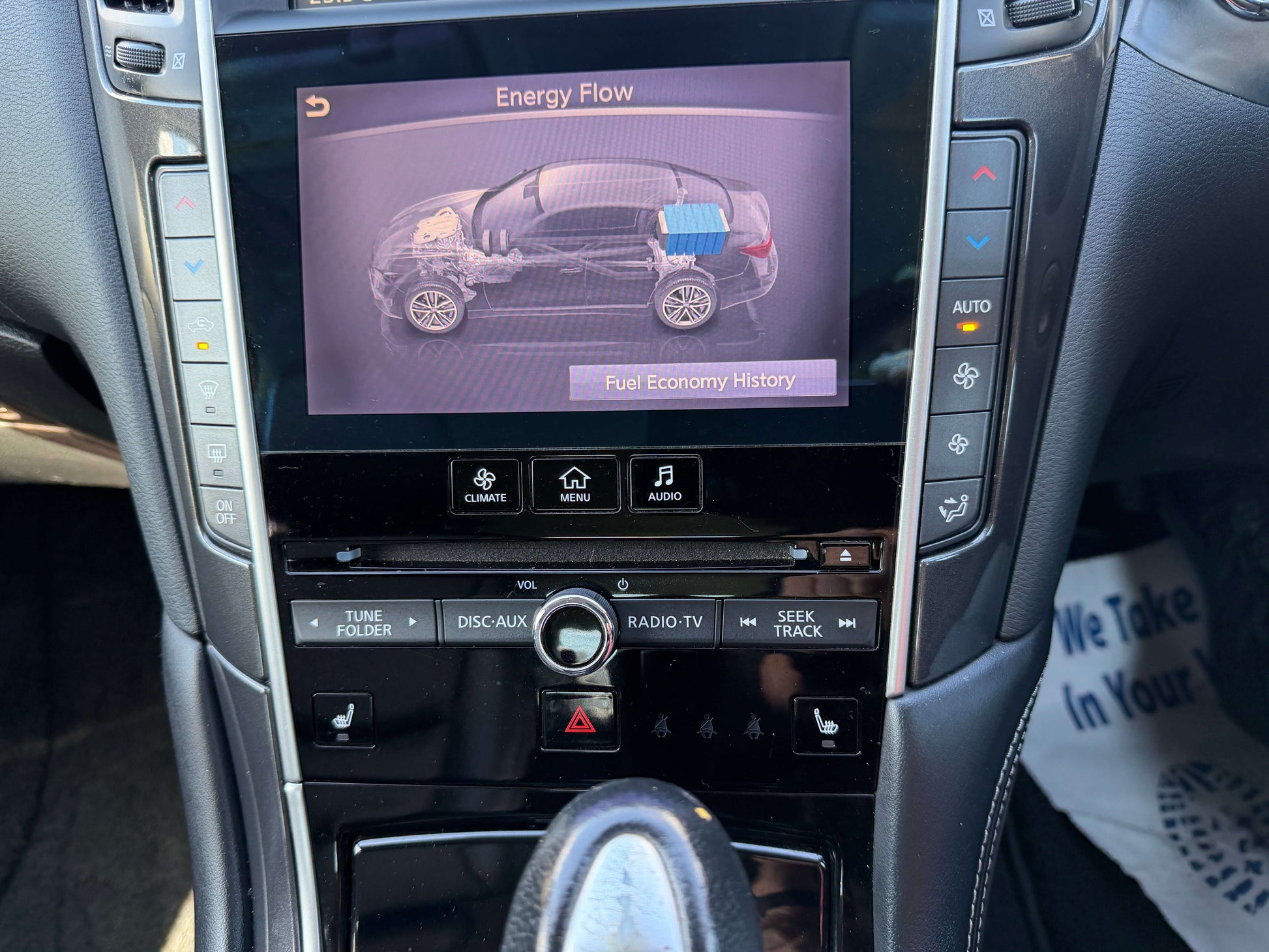 2014 Nissan Skyline V6 3.5L Hybrid screen displaying energy flow and fuel economy history.
