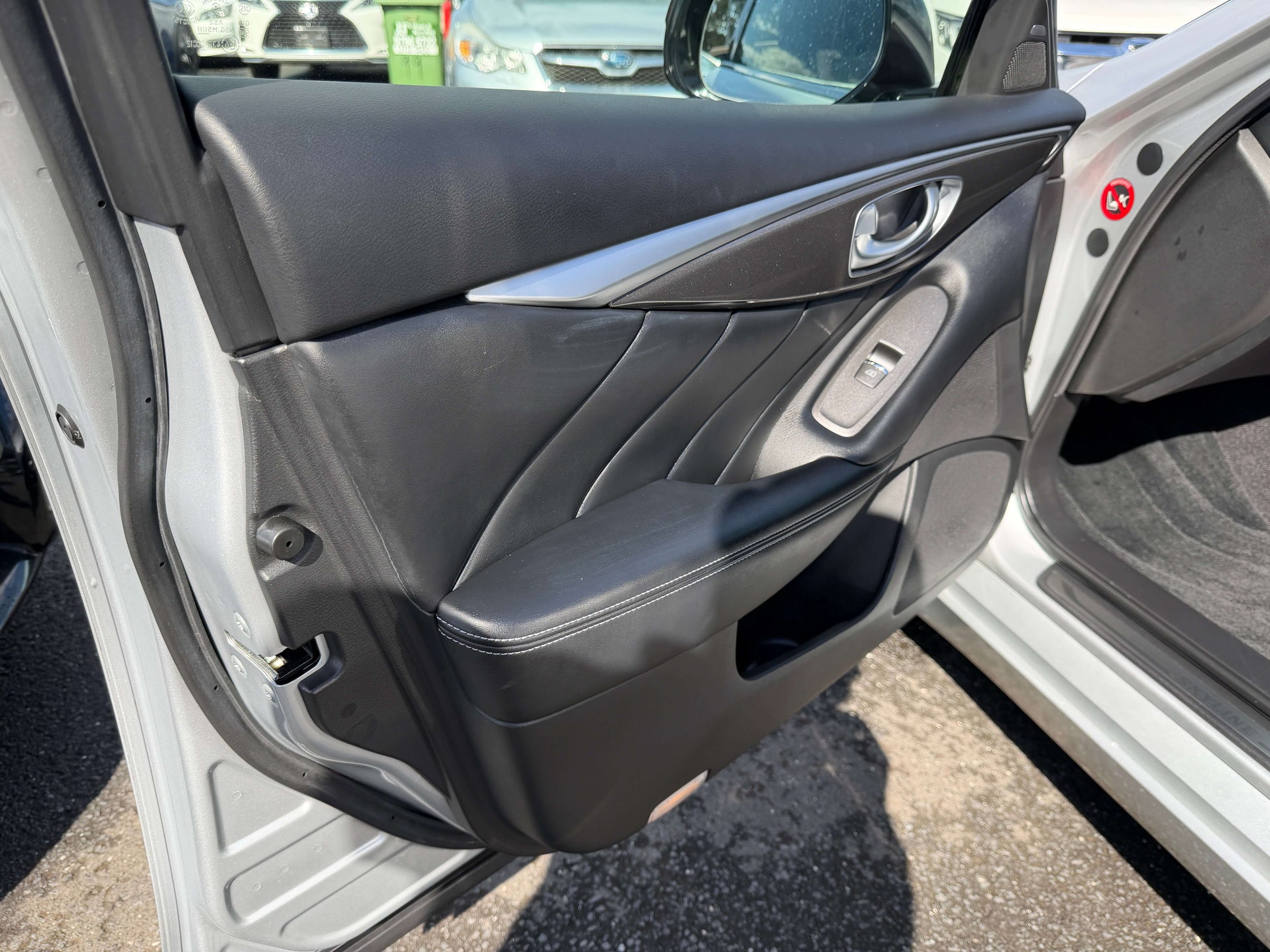 2014 Nissan Skyline V6 3.5L Hybrid front door interior view showcasing premium black leather trim and sleek design details.