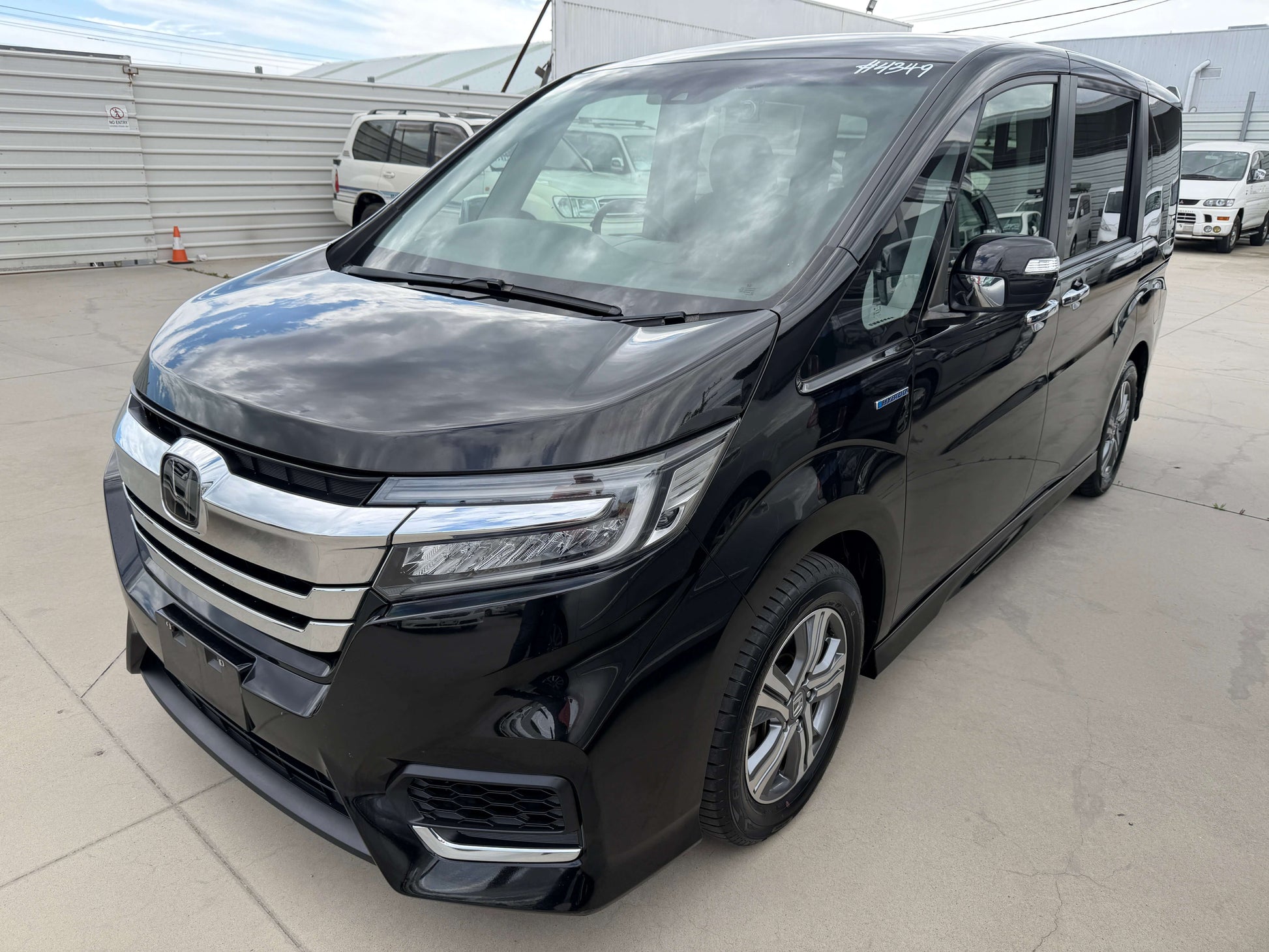 2018 Honda Honda Stepwgn 2.0 Spada Hybrid G parked outside, showcasing sleek black design and modern features.